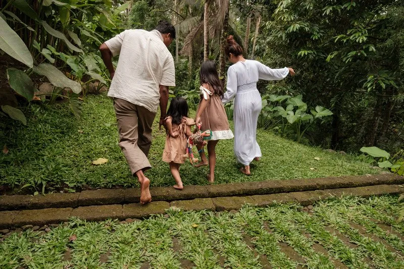 Family walking together along a sunny path