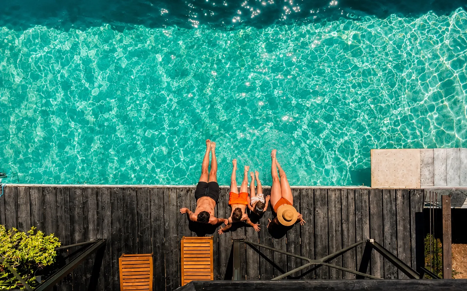 Overhead view of guests relaxing by the turquoise pool